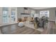Sunlit living room featuring modern furniture, a fireplace, and light wood floors at 3601 Carrollton Ave, Indianapolis, IN 46205