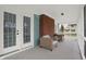 Relaxing screened porch with comfortable seating, featuring a red brick wall at 3601 Carrollton Ave, Indianapolis, IN 46205