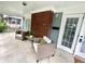 Inviting screened porch with chairs, a small table, and a view of the yard at 3601 Carrollton Ave, Indianapolis, IN 46205