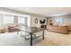 Finished basement area featuring a ping pong table, seating and neutral decor at 3641 Shady Lake Dr, Westfield, IN 46074