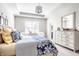 Primary bedroom featuring a tray ceiling, neutral walls, and dresser with a mirror at 3641 Shady Lake Dr, Westfield, IN 46074