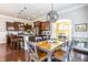 Dining area featuring hardwood floors, modern light fixture, and stainless steel appliances at 3641 Shady Lake Dr, Westfield, IN 46074