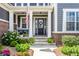 Charming front porch with white columns, American flag, and ample seating at 3641 Shady Lake Dr, Westfield, IN 46074