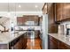 Modern kitchen with stainless steel appliances, granite countertops, and dark wood cabinetry at 3641 Shady Lake Dr, Westfield, IN 46074