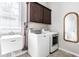 Laundry room featuring a washing machine, sink, cabinets and dryer at 3641 Shady Lake Dr, Westfield, IN 46074