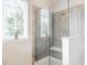 Tiled walk-in shower with glass enclosure, seat, and tiled walls at 3641 Shady Lake Dr, Westfield, IN 46074