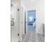 Bright bathroom featuring decorative tile flooring, a glass enclosed shower, and bedroom view at 365 N Grand Oak Dr, Mooresville, IN 46158