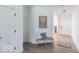 Well-lit foyer features a neutral bench, wood floors, and a view of the front door at 365 N Grand Oak Dr, Mooresville, IN 46158