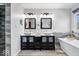 Bright bathroom features dual vanity sinks, contemporary mirrors, and a modern freestanding bathtub at 3976 Bent Tree Ln, Greenwood, IN 46143