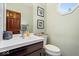 Powder room with white vanity, framed artwork, decorative mirror, and natural light at 3976 Bent Tree Ln, Greenwood, IN 46143