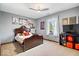 This bedroom features a ceiling fan, a window, and gray walls with artwork at 3976 Bent Tree Ln, Greenwood, IN 46143