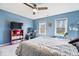 This bedroom has blue walls, a large bed, and 2 windows that let in a lot of light at 3976 Bent Tree Ln, Greenwood, IN 46143