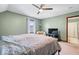 Bedroom with ceiling fan, one window, green walls, carpet floors, and bed at 3976 Bent Tree Ln, Greenwood, IN 46143