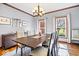 Bright dining room features a modern chandelier, hardwood floors, and an inviting atmosphere at 3976 Bent Tree Ln, Greenwood, IN 46143
