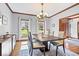 Light-filled dining room with hardwood floors and decor offers plenty of seating and style at 3976 Bent Tree Ln, Greenwood, IN 46143