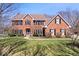 Charming brick home with a well-maintained lawn, symmetrical design, and mature trees providing shade and character at 3976 Bent Tree Ln, Greenwood, IN 46143