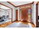 Elegant foyer boasting hardwood floors, decorative trim, and a view into the dining room at 3976 Bent Tree Ln, Greenwood, IN 46143