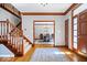 Inviting foyer with hardwood floors, staircase, and a view into the dining room at 3976 Bent Tree Ln, Greenwood, IN 46143