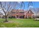 Stunning two-story brick home featuring a well-manicured lawn and beautiful landscaping at 3976 Bent Tree Ln, Greenwood, IN 46143