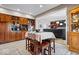 Kitchen area with built-in wood cabinets, an island table with stools, and an open layout to living room at 3976 Bent Tree Ln, Greenwood, IN 46143