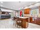 Spacious kitchen features a center island with bar seating, granite countertops, and wood cabinets at 3976 Bent Tree Ln, Greenwood, IN 46143