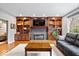 Inviting living room with hardwood floors, custom built-ins, and a cozy fireplace at 3976 Bent Tree Ln, Greenwood, IN 46143