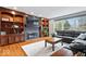 Spacious living room with natural light, hardwood floors, built-in shelves and a comfortable seating area at 3976 Bent Tree Ln, Greenwood, IN 46143