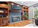 Close-up of living room featuring a fireplace, built-in shelving, and hardwood floors at 3976 Bent Tree Ln, Greenwood, IN 46143