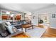 Open living room area with a large sectional sofa, hardwood floors, and views to other rooms at 3976 Bent Tree Ln, Greenwood, IN 46143