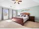 This main bedroom features a large picture window, wood frame bed and a light blue accent wall at 3976 Bent Tree Ln, Greenwood, IN 46143