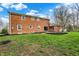 Large backyard with lush green grass, patio area, and brick exterior of the home at 40 Twinshore Ct, Carmel, IN 46033