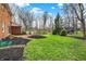 Landscaped backyard featuring a brick patio and a lush lawn, perfect for outdoor entertaining and relaxation at 40 Twinshore Ct, Carmel, IN 46033