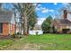 Spacious backyard with a partial lake view, mature trees, and lush green grass at 40 Twinshore Ct, Carmel, IN 46033