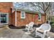 View of the patio with two rocking chairs, showcasing the brick exterior of the home at 40 Twinshore Ct, Carmel, IN 46033