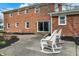 Relax on the patio with two rocking chairs, surrounded by landscaping and a brick exterior at 40 Twinshore Ct, Carmel, IN 46033