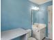 Bathroom with blue walls, vanity with sink, toilet and large mirror at 40 Twinshore Ct, Carmel, IN 46033