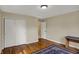 Neutral bedroom featuring hardwood floors, closet, and a view into another room at 40 Twinshore Ct, Carmel, IN 46033