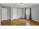 Bedroom with wood floor, window with dark curtains, and neutral walls at 40 Twinshore Ct, Carmel, IN 46033