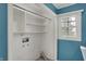Laundry room closet space with white shelves and natural light from a window at 40 Twinshore Ct, Carmel, IN 46033