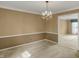 Carpeted dining room with chandelier and access to living areas, perfect for intimate dinners or gatherings at 40 Twinshore Ct, Carmel, IN 46033