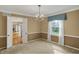 Elegant dining room connects to other living spaces, featuring a chandelier and a large window at 40 Twinshore Ct, Carmel, IN 46033