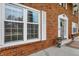 Close-up of a beautiful brick home featuring large windows and a welcoming entrance at 40 Twinshore Ct, Carmel, IN 46033