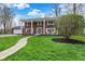Gorgeous brick home with a manicured lawn, stone walkway, and mature landscaping at 40 Twinshore Ct, Carmel, IN 46033
