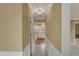Hallway view leading to a bright kitchen with white cabinets and hardwood floors at 40 Twinshore Ct, Carmel, IN 46033