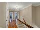 Hallway with hardwood floors, chandelier, and a view into other rooms at 40 Twinshore Ct, Carmel, IN 46033