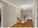 Upstairs hallway boasts hardwood floors, a chandelier, and staircase at 40 Twinshore Ct, Carmel, IN 46033