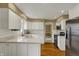 Spacious kitchen with white cabinets, stainless steel appliances, and hardwood floors at 40 Twinshore Ct, Carmel, IN 46033