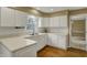 Bright kitchen featuring white cabinets, countertops, and a stainless steel sink and faucet at 40 Twinshore Ct, Carmel, IN 46033