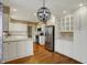 Well-appointed kitchen with stainless appliances, white cabinets, and spacious hardwood flooring at 40 Twinshore Ct, Carmel, IN 46033