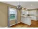 Open-concept kitchen features white cabinets, countertops and dining area with chandelier lighting at 40 Twinshore Ct, Carmel, IN 46033